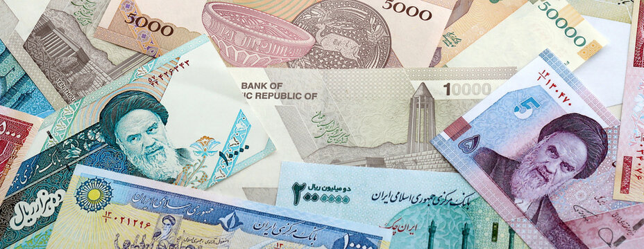 Iranian rial money banknotes pile on table. Iran bills of IRR currency close up. Concept of economy