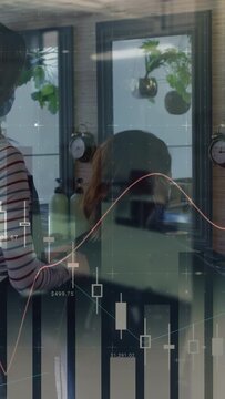 Vertical video: Stylist reaching across head, shaping haircut while finance chart overlaying salon
