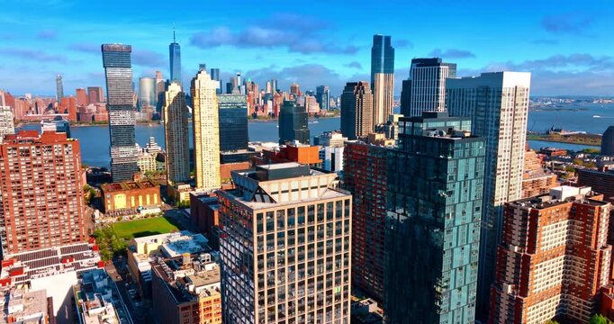 Approaching the top of the high-rise building in the urban landscape of Jersey City, New Jersey, USA. Manhattan skyline across the river in the backdrop.