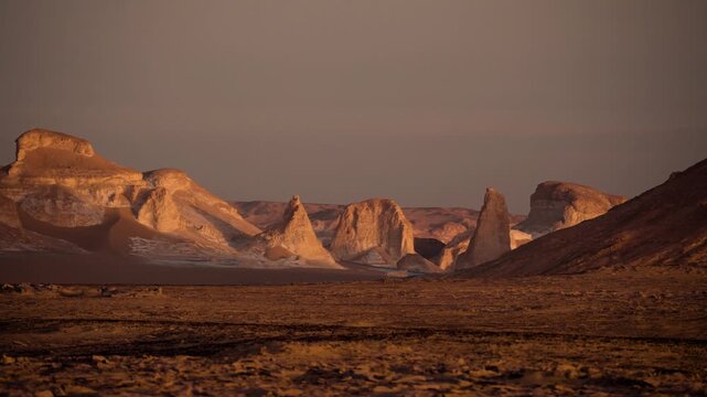 Wind-sculpted limestone formations in Egypt&rsquo;s White Desert at sunrise. Cinematic sequence of wind-sculpted limestone formations in Egypt&rsquo;s White Desert during early morning.