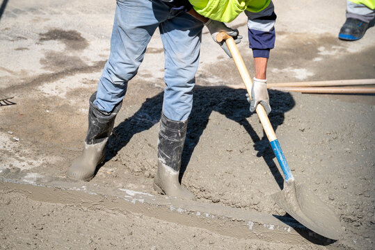 Builder leveling a concrete foundation at worksite The Concept of building