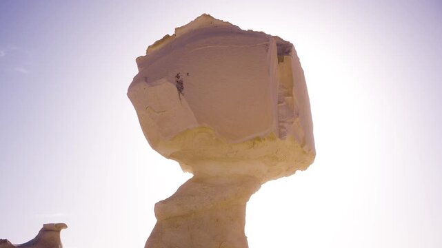 Mini flight around mushroom-shaped limestone formation in Egypt&rsquo;s White Desert at sunrise. Mini-story composed of two shots: first a wider view, then a closer view, smoothly orbiting a mushroom-shaped