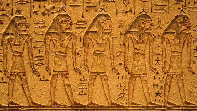 Ancient Egyptian hieroglyphs on tomb walls, Valley of the Kings, Luxor. Close-up of colorful Egyptian hieroglyphs and symbols on interior tomb walls in the Valley of the Kings. 