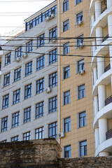 Fototapeta premium air conditioner, condenser unit, compressor on facade of building. unit of central AC conditioner of HVAC heating ventilation system. Indoor and office air cooling during seasonal temperature rise.