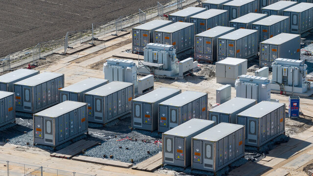 Espel, Netherlands - 04 April 2026: Aerial view of the Hoogspanningsstation - Westermeerdijk battery storage facility with rows of grey power units and transformers on a construction site.