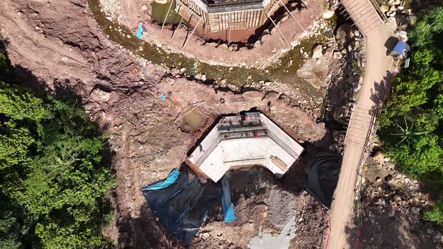 Civil Engineering Infrastructure: Concrete Bridge Foundations and Workers over Stream