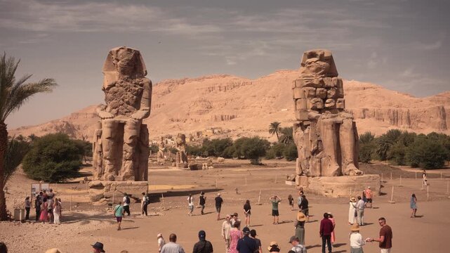 Colossi of Memnon, Luxor, Egypt &ndash; iconic ancient statues. Cinematic footage of the Colossi of Memnon in Luxor, Egypt, showcasing the massive ancient stone statues from various angles.