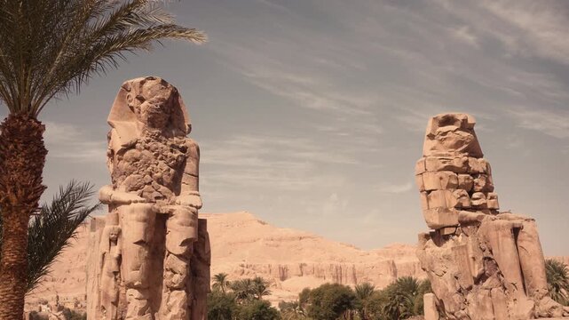 Colossi of Memnon, Luxor, Egypt &ndash; iconic ancient statues. Cinematic footage of the Colossi of Memnon in Luxor, Egypt, showcasing the massive ancient stone statues from various angles.