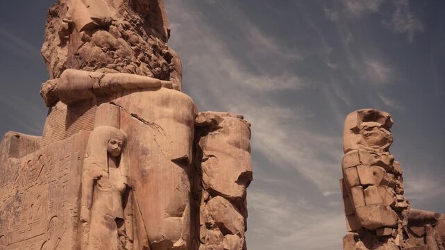 Colossi of Memnon, Luxor, Egypt &ndash; iconic ancient statues. Cinematic footage of the Colossi of Memnon in Luxor, Egypt, showcasing the massive ancient stone statues from various angles.