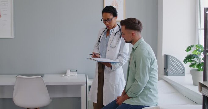 Doctor and patient in clinic consultation. A female professional concludes medical visit, offering diagnosis, therapy, and next steps at appointment. Healthcare trust shown by handshake.