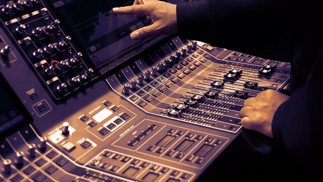 Mixing operation. Professional audio or sound engineers operating digital mixing consoles in studio or live mix perform. Sound control music production broadcasting mix and live event audio technology