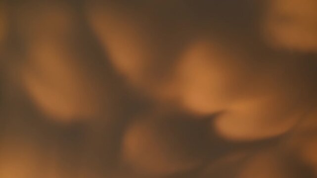 Time-lapse of billowing evening clouds moving across the sky and filling the frame with dramatic shifting light, color, and atmospheric motion