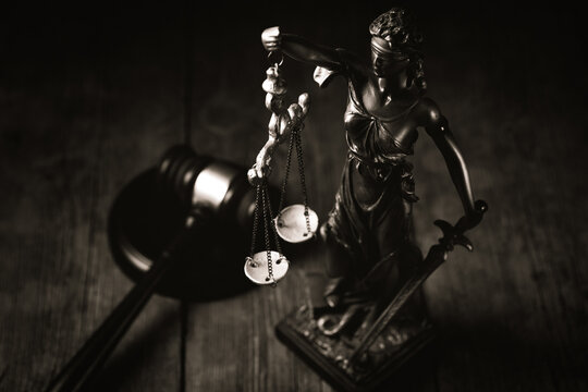 Statue of justice on wooden background. Law and justice concept.