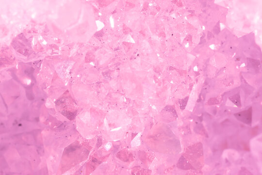 Amethyst pink crystals. Gems. Mineral crystals in the natural environment. Texture of precious and semiprecious stones. Seamless background with copy space colored shiny surface of precious stones.