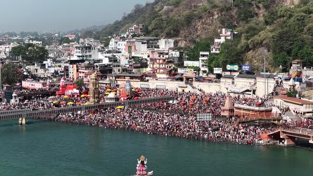 push in aerial view of har ki pauri, haridwar with crowd of devotees.