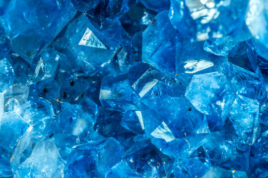 Blue Crystal Mineral Stone. Gems. Mineral crystals in the natural environment. Texture of precious and semiprecious stones. Seamless background with copy space colored shiny surface of precious stones