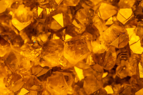 Golden crystal mineral stone. Gems. Mineral crystals in the natural environment. Texture of precious and semiprecious stones. Seamless background with copy space.