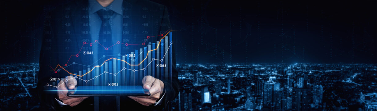 A businessman in a suit holds a tablet, showcasing financial graphs against a nighttime city skyline, symbolizing growth, technology, and investment strategies. Scalp