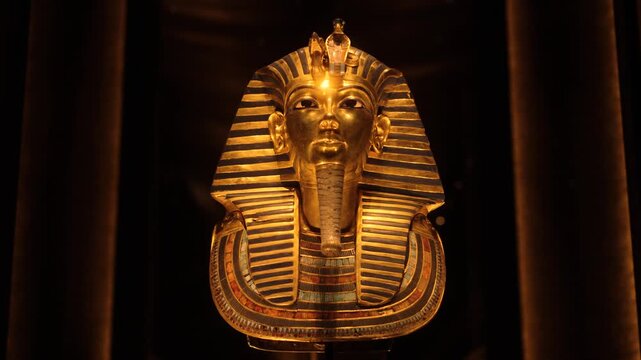 Close-up of Tutankhamun golden mask, Egypt. Detailed close-up of the original golden mask of Tutankhamun, the ancient Egyptian pharaoh. The shot highlights the intricate craftsmanship