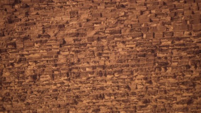 Zoom in from Great Pyramid of Giza to ancient stone blocks texture Egypt architectural detail Khufu monument. A smooth zoom in transitions from the Great Pyramid of Giza
