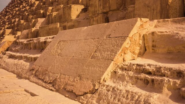 Close-up of original casing stones at base of Great Pyramid of Giza architectural detail sunrise Egypt. A close-up of a small section of the original casing stones at base of Great Pyramid of Giza