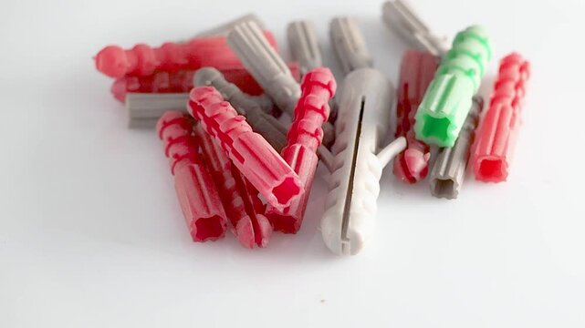 Colorful plastic screw dowels isolated on a white background