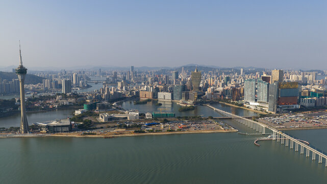 Macao - 18 February 2026: Aerial view of the Macau Tower and Grand Lisboa Hotel overlooking Nam Van Lake and the city skyline under a clear blue sky.
