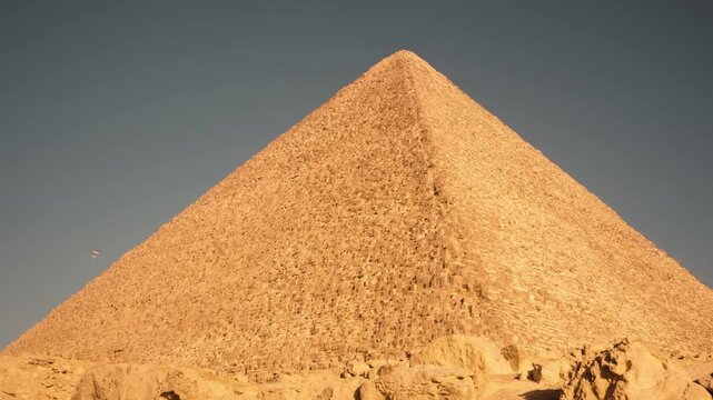 Golden morning view of the Great Pyramid of Khufu &ndash; horizontal Steadicam shot. A cinematic Steadicam shot of Great Pyramid of Khufu in the early morning light. The camera glides smoothly to the right