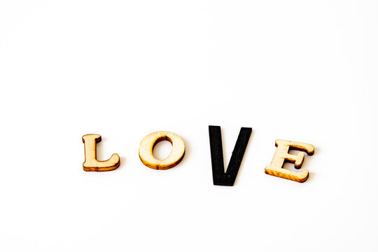 valentines message love in wooden letters the type V is black and bigger than the other types
