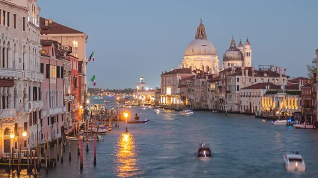 Day to night transition hyper lapse Grand Canal traffic and Basilica di Santa Maria della Salute, view from Accademia bridge, Venice, Italy
