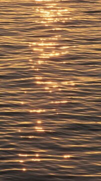 Golden sunlight ocean water surface slow motion
