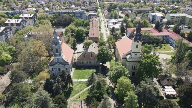 Aerial drone panorama of Vrbas, Serbia, highlighting dominant church towers.