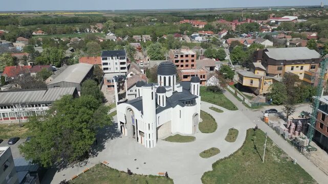 Aerial drone orbit around Serbian Orthodox church in the city center of Vrbas, northern Serbia.