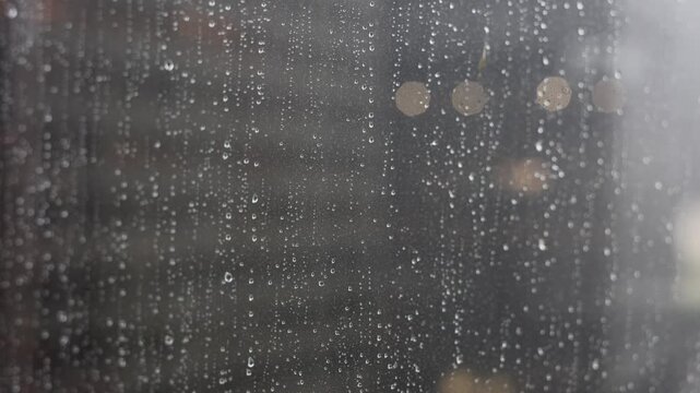 Rain Drops Against Glass In Urban Setting