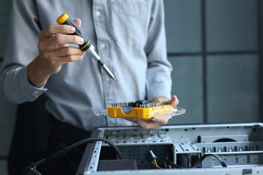 A computer technician repairing or assembling a desktop computer.