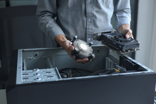Close up of electronic technician hands working on computer repair.