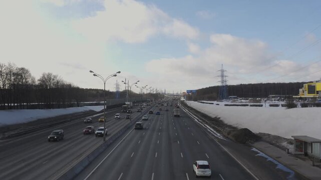4K timelapse of busy evening traffic on Moscow Ring Road (MKAD). Static shot with continuous car movement, urban atmosphere and city transport flow at dusk.
