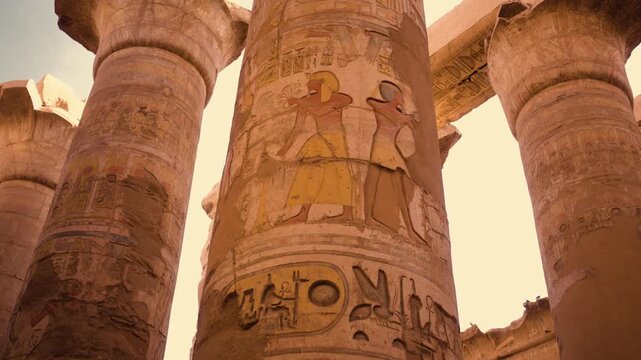 Hypostyle Hall columns, Temple of Karnak, Luxor. Ancient columns of the Hypostyle Hall at the Temple of Karnak in Luxor, Egypt. Sunlight streams between the columns