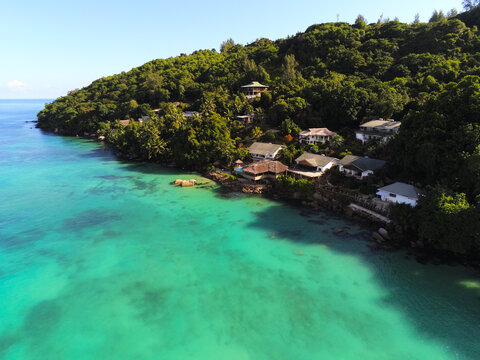Baie Ste Anne, Seychelles - 05 April 2026: Aerial view of Colibri Guesthouse nestled on a lush green hillside overlooking the turquoise waters of the Indian Ocean.