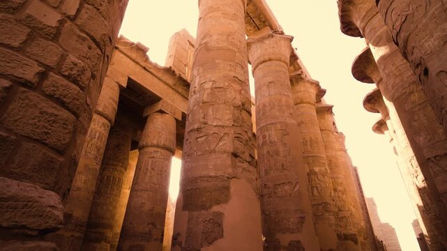 Hypostyle Hall columns, Temple of Karnak, Luxor. Ancient columns of the Hypostyle Hall at the Temple of Karnak in Luxor, Egypt. Sunlight streams between the columns