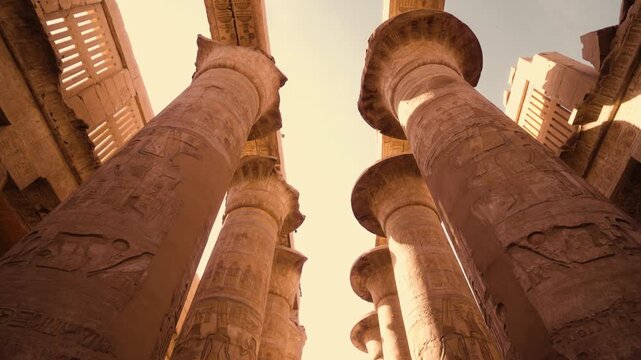 Hypostyle Hall columns, Temple of Karnak, Luxor. Ancient columns of the Hypostyle Hall at the Temple of Karnak in Luxor, Egypt. Sunlight streams between the columns
