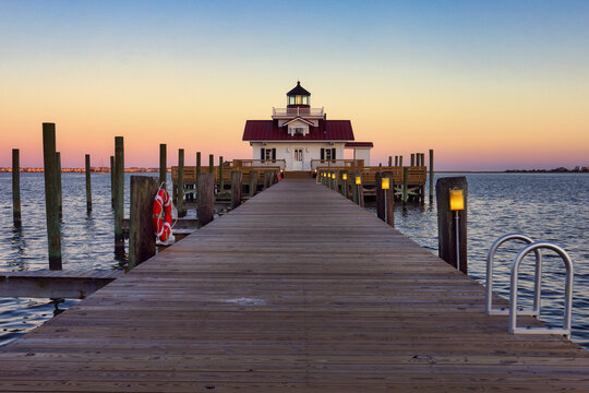An wide-angle view down the pier aat the Roanoke Marshes Lighthouse in beautiful Manteo, in North Carolina USAt sunset