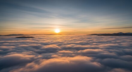 Obraz premium Golden Sunset Over Vast Sea of Clouds with Distant Mountains from Aerial Viewpoint