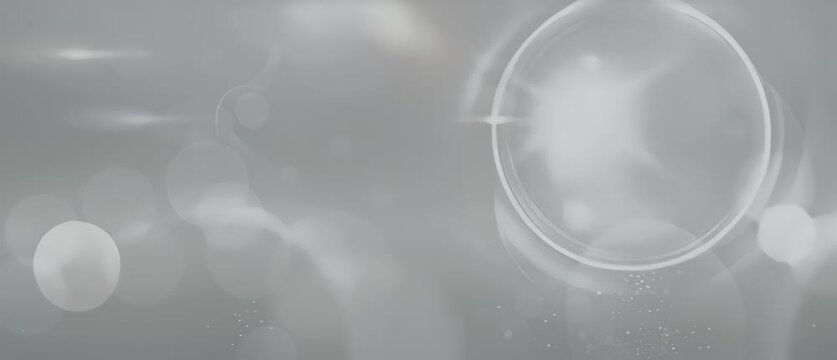 Abstract gray background with circular light flares and bokeh effect