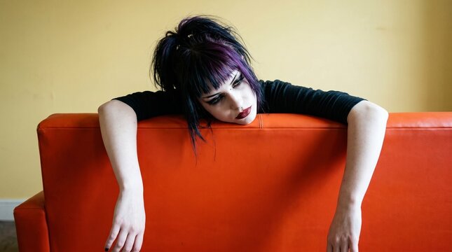 This image is a metaphor for the profound apathy of a "burnt-out" soul. The limp posture over the vibrant sofa represents a colorful life drained of its energy, leaving only a heavy, hollow ennui.