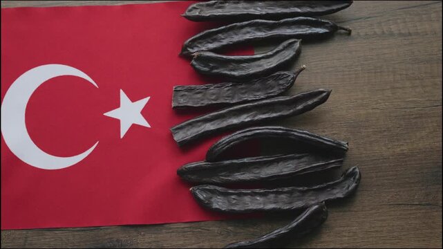 Close-up of carob pods on Turkish flag 