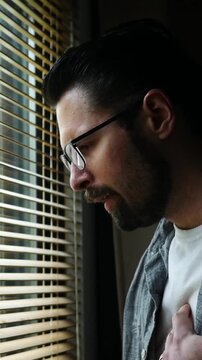  Man in his thirties experiences heart or chest pain - health concept - Vertical