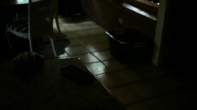 Man Falls or Injured and Attempts to Grab Phone on Counter