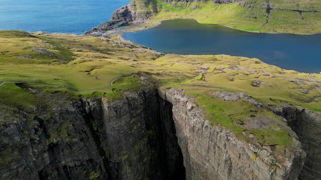 Cinematic 4K aerial top-down drone view of waves crashing at the rocky coast near Gjogv, Faroe islands, Denmark