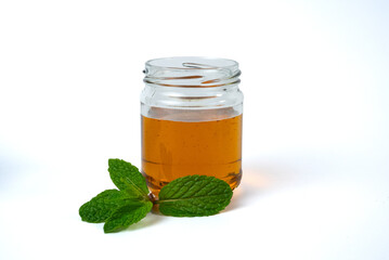 Honey jar and mint leaves minimal food concept © SVITLANA